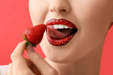 Beautiful young woman with unusual makeup and strawberry on color background, closeup