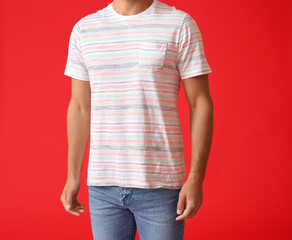 Obraz premium Man in Striped T-shirt and Blue Jeans