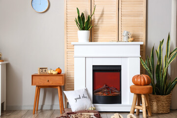 Interior of living room with autumn decor and fireplace