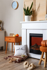 Fototapeta na wymiar Interior of living room with autumn decor and fireplace