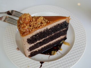 chocolate cake in a white plate on table.