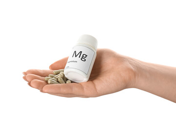 Female hand with magnesium capsules and bottle on white background, closeup