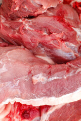 Defocus texture or background of tasty fresh meat of big, pork. Red beef meat close up texture. Meat food background. Blurred. Vertical. Out of focus