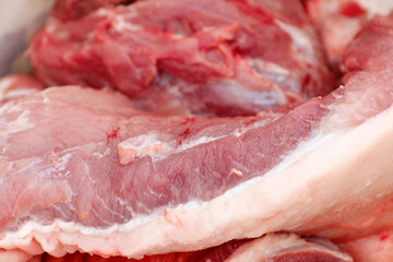 Defocus texture or background of tasty fresh meat of big, pork. Red beef meat close up texture. Meat food background. Blurred. Fresh meat. Ukrainian salo. Out of focus