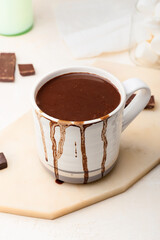 Cup of natural hot chocolate on white background