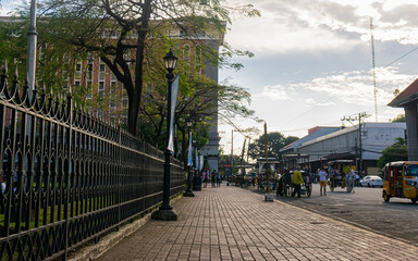 Fototapeta na wymiar Walking along the sidewalk in park. Intramuros, Manila, Philippines