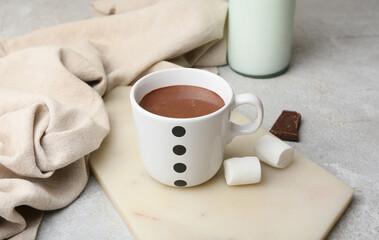 Fototapeta na wymiar Cup of natural hot chocolate with marshmallow on light background