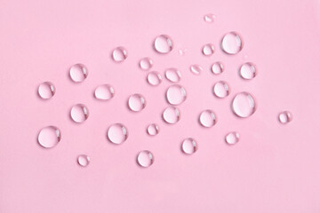 Many water drops on pink background