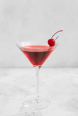 Glass of delicious Manhattan cocktail on light background