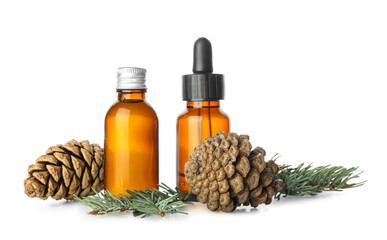 Bottles of essential oil and pine cones isolated on white background