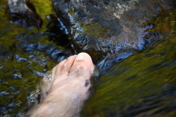 Foot of man during dip in water scene.
