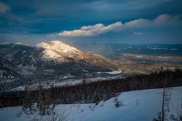 Sunbeam over isolated Dufour mountain at sunset, Charlevoix, QC, Canada