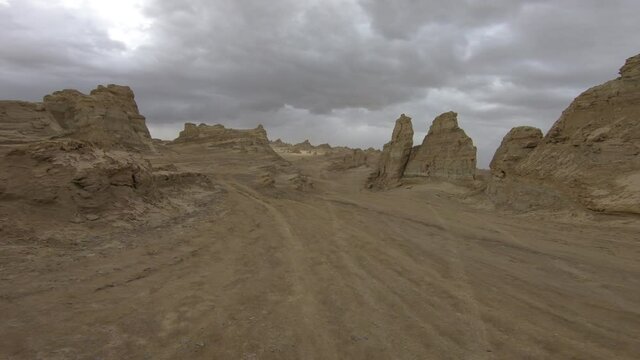 Car running in the sunset yardang landform area in China