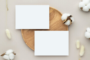 Blank paper cards, Greeting card Mockup with pampas grass on a wooden plate, beige background, Minimal beige workplace composition, flat lay, mockup