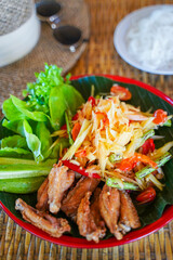 Papaya salad with deep fried chicken