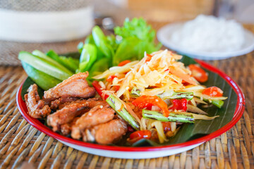 Papaya salad with deep fried chicken