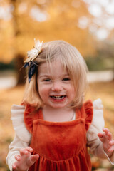 Smiling young girl in the autumn