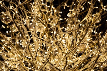 Glittering colorful Christmas decorations in golden, yellow and white colors