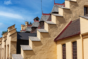 The facade of a typical Bavarian house with a red tiled roof, balconies and wooden shutters near Fussen in Bavaria, Germany