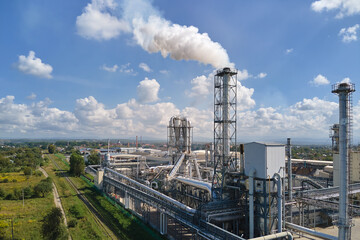 Obraz premium Aerial view of oil and gas refining petrochemical factory with high refinery plant manufacture structure. Global production and manufacturing concept