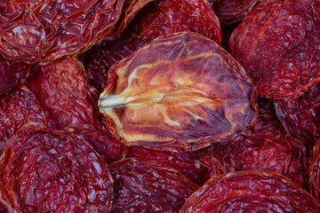 Background of sun-dried tomatoes. Dried tomatoes.