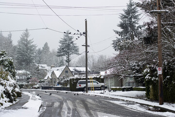 Street scene in a suburban neighborhood in Portland, Oregon, on a cold winter day after snowfall....