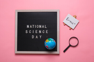 Composition Flat lay of a blackboard with the inscription national science day isolated on a pink...