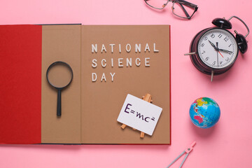 Flat lay composition of Books with national science day isolated on pink background