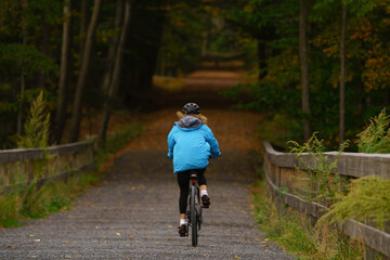 person riding a bicycle in forest