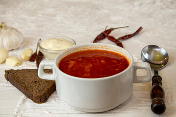 Ukrainian borsch. Traditional dish of Ukraine. Red borscht on a white plate.