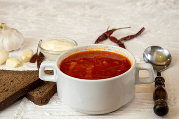 Ukrainian borsch. Traditional dish of Ukraine. Red borscht on a white plate.