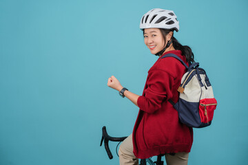 Asian beautiful woman is riding a city bike to work and showing yes gesture