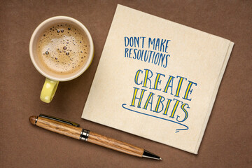 do not make resolutions, create habits -  inspirational advice or reminder on a napkin, New Year...