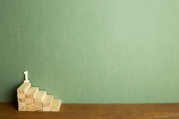 Wood block stairs with number on desk. green background. development, growth, success concept