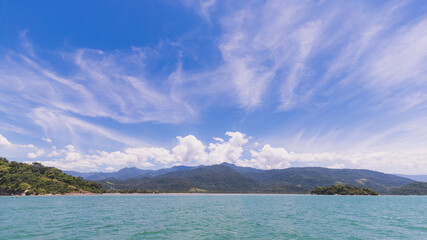 Island under blue sky in blue sea