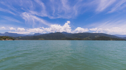 Island under blue sky in blue sea