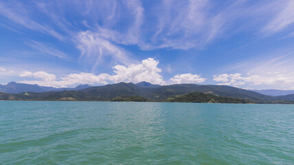 Island under blue sky in blue sea