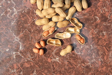 Bunch of peeled peanuts on tile view from above