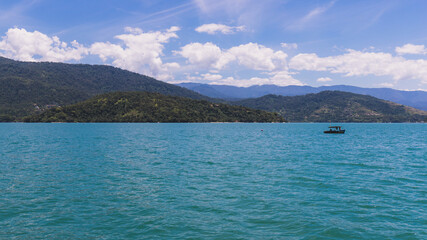 Island under blue sky in blue sea