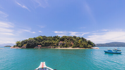 Island under blue sky in blue sea