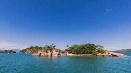 Island under blue sky in blue sea