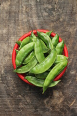 Fresh green beans on a red bowl