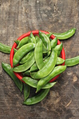 Fresh green beans on a red bowl