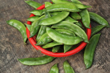 Fresh green beans on a red bowl