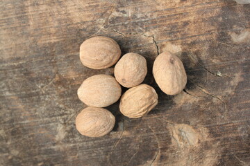 Dried nutmeg on a wooden table