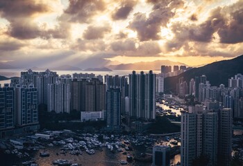 Obraz premium Hong Kong city skyline with dramatic clouds and sunset with beautiful light