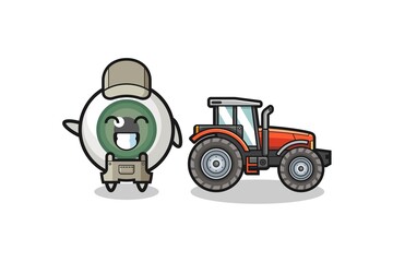 the eyeball farmer mascot standing beside a tractor