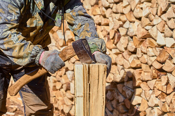 chopping firewood with a chopper close-up on a sunny day