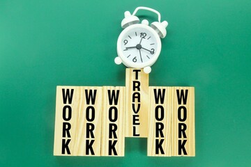 alarm clock, wooden board with the words work and travel. the concept of working leave.