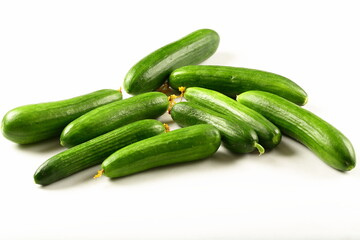Fresh green  cucumbers on a white background. vegetarian raw foods.